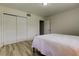 Bedroom with wood-look floors, a large closet with sliding doors, and a comfortable neutral bedspread at 1868 Lombardy Dr, Clearwater, FL 33755