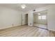 Spacious bedroom featuring wood-look floors, a closet with mirror doors, a ceiling fan, and a bright window at 1868 Lombardy Dr, Clearwater, FL 33755