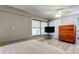 Bedroom featuring light gray walls, wood floors, a bed, dresser and a window at 1868 Lombardy Dr, Clearwater, FL 33755