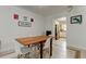 Dining area shows view into kitchen with stainless steel refrigerator at 1868 Lombardy Dr, Clearwater, FL 33755