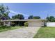 Single-story home featuring a well-maintained lawn and an attached two-car garage at 1868 Lombardy Dr, Clearwater, FL 33755
