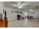 Spacious living room features modern ceiling fan, wood-look flooring, and is decorated with art at 1868 Lombardy Dr, Clearwater, FL 33755