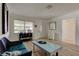 Cozy living room featuring neutral paint, hard surface flooring and a modern coffee table at 1868 Lombardy Dr, Clearwater, FL 33755