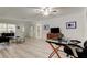 Bright living room featuring light wood flooring, and decorative windows by front door at 1868 Lombardy Dr, Clearwater, FL 33755