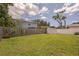 Spacious backyard with lush green grass and a white storage shed, perfect for outdoor activities and storage solutions at 1882 Maryland Ne Ave, St Petersburg, FL 33703