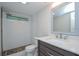 A renovated bathroom showcasing a tiled shower, a toilet, and a stone floor design at 1882 Maryland Ne Ave, St Petersburg, FL 33703