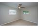 A bright bedroom featuring two windows and a ceiling fan, offering a comfortable and airy space at 1882 Maryland Ne Ave, St Petersburg, FL 33703