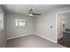 A cozy bedroom featuring neutral carpet, a ceiling fan, and view of the kitchen at 1882 Maryland Ne Ave, St Petersburg, FL 33703