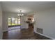 Bright dining area with sliding glass doors to the patio, wood floors, and modern light fixture at 1882 Maryland Ne Ave, St Petersburg, FL 33703
