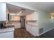 A renovated kitchen with white cabinets, marble countertops, and stainless steel appliances at 1882 Maryland Ne Ave, St Petersburg, FL 33703