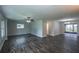 Spacious living room with wood floors, ceiling fan, and sliding glass doors to the backyard at 1882 Maryland Ne Ave, St Petersburg, FL 33703