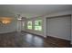 Bright living room with wood floors, a ceiling fan, and large windows offering natural light at 1882 Maryland Ne Ave, St Petersburg, FL 33703