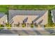 Birds eye view of the townhouse and the front yards with landscaping, driveways, and street at 19272 Blue Pond Dr, Lutz, FL 33558