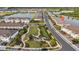 Aerial neighborhood park surrounded by modern townhomes and green spaces, offering a serene atmosphere at 19272 Blue Pond Dr, Lutz, FL 33558