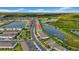 Scenic aerial view of townhomes along the water, featuring lush landscaping and community green space at 19272 Blue Pond Dr, Lutz, FL 33558