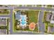 An aerial view of a community pool, playground, seating areas, and parking available to community residents at 19272 Blue Pond Dr, Lutz, FL 33558