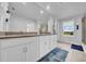 Bright bathroom features double sinks, a large mirror, and a window providing natural light and views of the property at 19272 Blue Pond Dr, Lutz, FL 33558