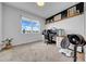 Comfortable carpeted bedroom with large window and custom desk setup at 19272 Blue Pond Dr, Lutz, FL 33558
