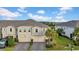 Beautiful townhome with a well manicured lawn, paver driveway, and two-car garage at 19272 Blue Pond Dr, Lutz, FL 33558