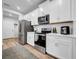 Modern kitchen featuring stainless steel appliances, white cabinetry, and ample counter space at 19272 Blue Pond Dr, Lutz, FL 33558