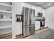 Updated kitchen featuring stainless steel refrigerator and appliances with modern white cabinets at 19272 Blue Pond Dr, Lutz, FL 33558