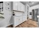 Bright kitchen area with white cabinets, subway tile backsplash, and stainless steel refrigerator at 19272 Blue Pond Dr, Lutz, FL 33558