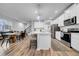 Open kitchen and dining area with white cabinets, a large island, and modern appliances at 19272 Blue Pond Dr, Lutz, FL 33558