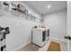 Clean laundry room with modern appliances, storage shelves, and neutral walls, perfect for efficient chore completion at 19272 Blue Pond Dr, Lutz, FL 33558