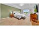 Inviting main bedroom boasting tray ceilings, a king bed, and ample natural light at 19272 Blue Pond Dr, Lutz, FL 33558