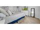Inviting main bedroom with a large bed, dresser, and neutral decor, creating a cozy and stylish retreat at 19272 Blue Pond Dr, Lutz, FL 33558