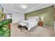 Comfortable main bedroom featuring tray ceilings and a king bed with decorative plants at 19272 Blue Pond Dr, Lutz, FL 33558