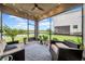View of screened-in patio featuring views of the yard, outdoor seating, and string lights at 19272 Blue Pond Dr, Lutz, FL 33558