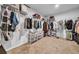Spacious walk-in closet with ample storage, shelving, and clothing racks for optimal organization and accessibility at 19272 Blue Pond Dr, Lutz, FL 33558