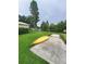 Green backyard featuring a concrete landing near the water and a yellow kayak at 2014 Nancy Ave, Lutz, FL 33548