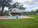 Backyard view with a private pool, slide, and screened-in patio at 2014 Nancy Ave, Lutz, FL 33548
