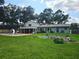 Spacious backyard with a private pool, slide, screened-in patio and garden at 2014 Nancy Ave, Lutz, FL 33548