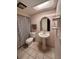 Neutral bathroom featuring a pedestal sink, patterned shower curtain, and skylight at 2014 Nancy Ave, Lutz, FL 33548
