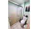 Compact bathroom featuring a sliding glass door shower and toilet at 2014 Nancy Ave, Lutz, FL 33548