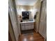 Narrow bathroom featuring vanity with sink, two doors, and bright lighting at 2014 Nancy Ave, Lutz, FL 33548