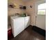 Practical laundry room including a washer, dryer, and shelving at 2014 Nancy Ave, Lutz, FL 33548