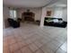 Spacious living room featuring tile flooring and a stone fireplace at 2014 Nancy Ave, Lutz, FL 33548