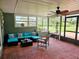 Enclosed sunroom featuring comfortable seating, tile flooring, and natural light at 2014 Nancy Ave, Lutz, FL 33548