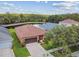 Aerial view of charming single Gathering home with water view, landscaping, and an attached two car garage at 20244 Merry Oak Ave, Tampa, FL 33647