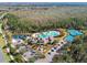 Aerial view showcases community amenities: swimming pool, tennis courts, playground, community center, and parking area at 20244 Merry Oak Ave, Tampa, FL 33647