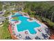 A picturesque aerial view of a community pool, splashpad, and lounge areas, providing a resort-like experience for residents at 20244 Merry Oak Ave, Tampa, FL 33647