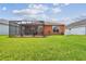 Expansive backyard featuring a screened-in lanai perfect for outdoor entertaining at 20244 Merry Oak Ave, Tampa, FL 33647