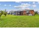 Lush green backyard with a screened-in patio, perfect for enjoying the outdoors at 20244 Merry Oak Ave, Tampa, FL 33647