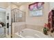 Relaxing bathroom showcasing a soaking tub and a glass-enclosed shower at 20244 Merry Oak Ave, Tampa, FL 33647