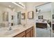 Bathroom with double sinks and a vanity area, leading into an adjacent bedroom at 20244 Merry Oak Ave, Tampa, FL 33647