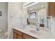 Bathroom featuring a double sink vanity with granite countertops and neutral decor at 20244 Merry Oak Ave, Tampa, FL 33647